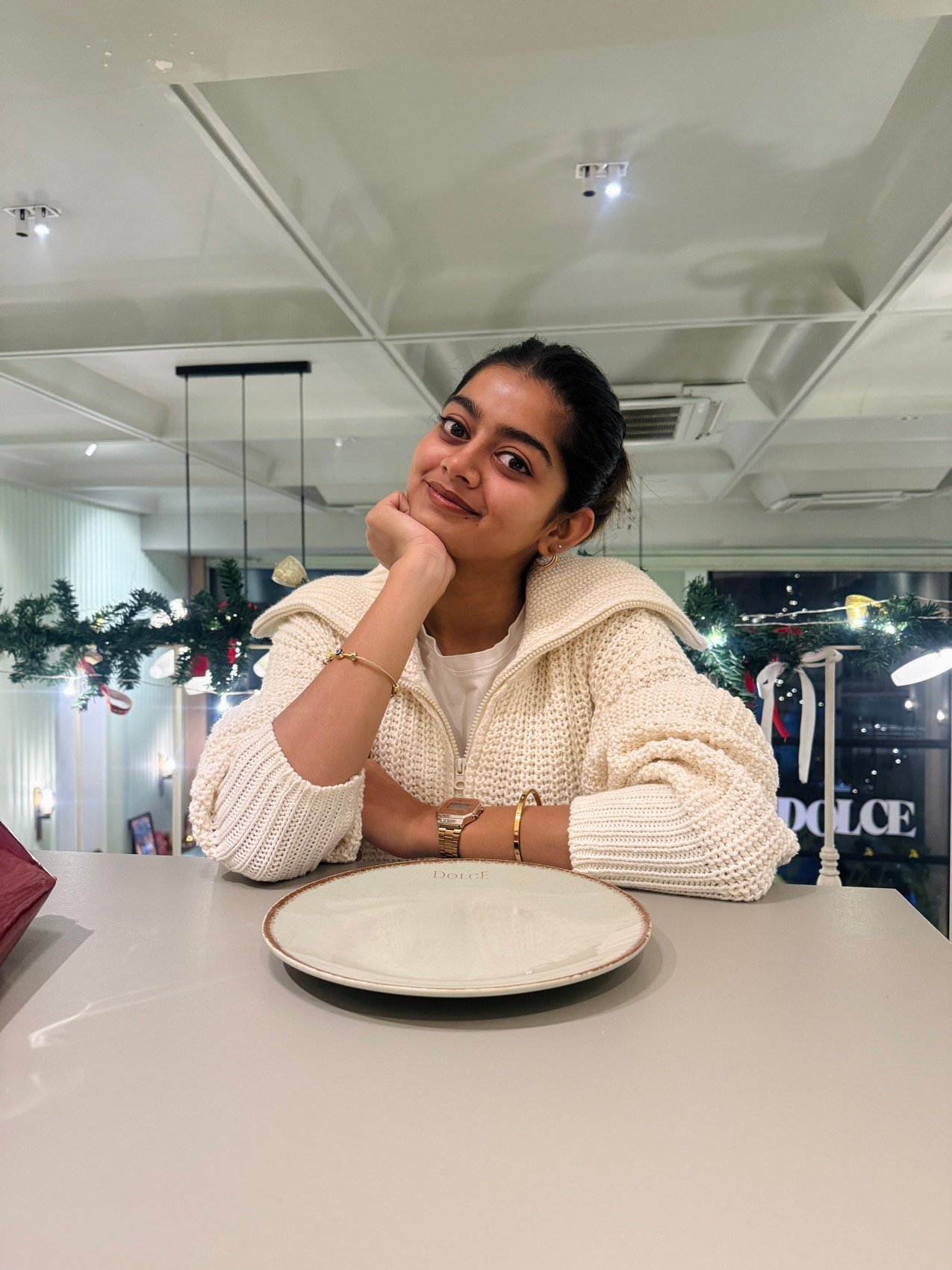 Café shoot in a cream knit cardigan